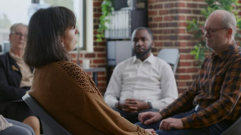 Close up of sad woman during a restorative justice group session